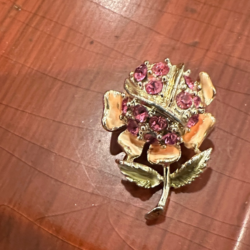 Vintage 1960s pin with pink rhinestone and enamel accents.
